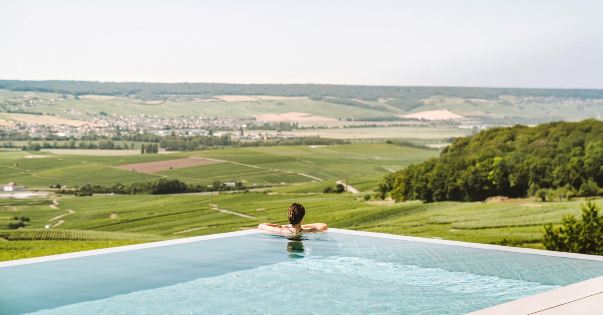 Infinity pool overlooking green vineyards